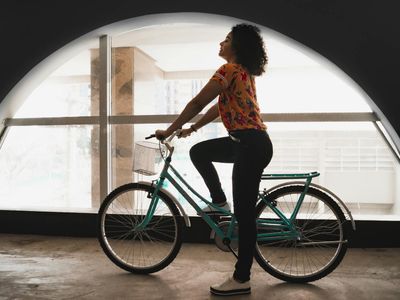 Silhouette of a person in a balance pose against a window.